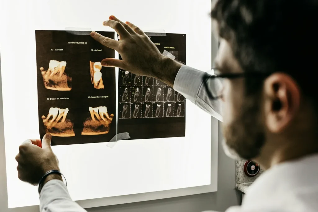 A dentist examining dental X-rays