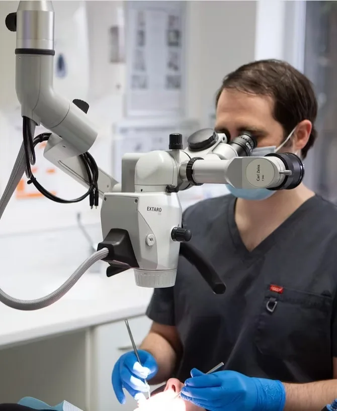 Dr Rob Jacobs, our Specialist Endodontist, working under the dental operating microscope at Treetops